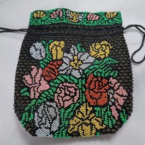 Beaded bag 9 inches in length and 8 inches in width.  Lined with drawstring.